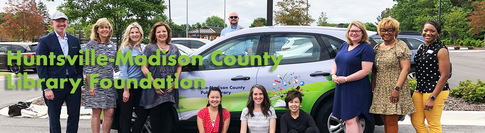 Board members in front of library vehicle